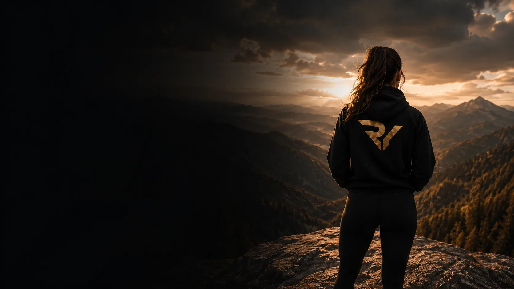 Woman in a Resurrect You hoodie overlooking mountains at sunrise